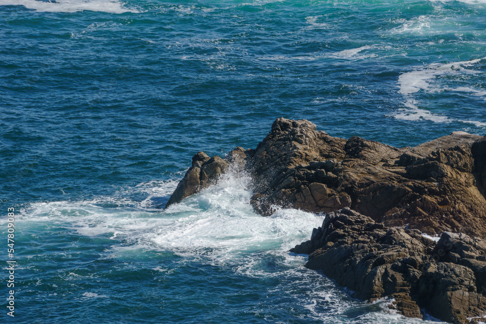 Rocks at the coastline in the waves of the sea at Pointe du Van ...