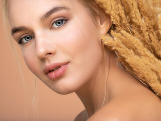 Poster - Portrait of young beautiful woman with a healthy  skin of face.  Attractive girl with a bunch spring field flowers