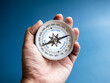 © tete_escape - Closeup blue words 'SUCCESS' on compass in businessman's hand on blue background. Business goal and success, plan and direction concepts with target as motivation.