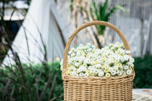 A Flower Basket On The Table With Blur Background.