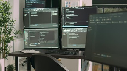 Desk with multiple monitors displaying terminal window and artificial intelligence programming code. Empty software developing agency office with servers cloud computing, html script.