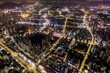 Aerial long exposure view of a futuristic illuminated city at night