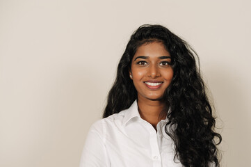 Young brunette indian woman smiling and looking at camera