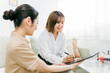 © buritora - 美容系サロンでタブレットの契約書に電子サインするカウンセラースタッフと相談する日本人女性