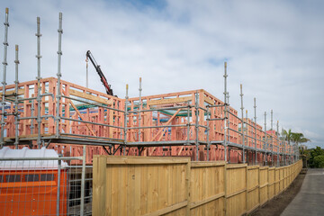 Residential houses under construction with metal scaffolding around them. Auckland.