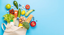 Shopping Bag Full Of Healthy Food On Blue