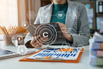 Wall Mural - Copyright or patent concept, Person hand using laptop computer, tablet and smartphone with virtual screen copyright icon trademark, Creation ownership against piracy.
