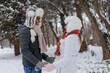 © Westend61 - Happy young man with woman standing at park in winter