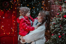 Cheerful Mother With Son Enjoying In Snow