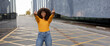 © Westend61 - Happy young woman showing middle finger at footpath