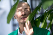 © Westend61 - Thoughtful senior woman holding fig leaf