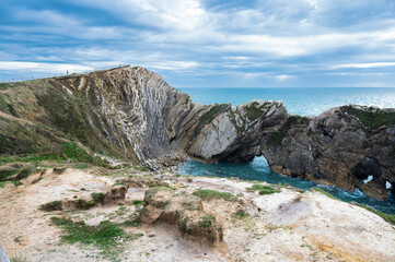 Wall Mural - Beautiful view of Stair Hole, small cove to the west of Lulworth Cove in Dorset, Untited Kingdom. View of rock formations and nature made caves and blue sea, selective focus