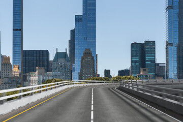 Empty urban asphalt road exterior with city buildings background. New modern highway concrete construction. Concept of way to success. Transportation logistic industry fast delivery. New York. USA.