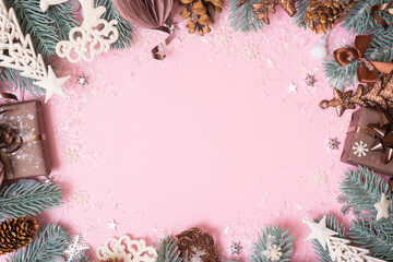 Wall Mural - Frame made frome pine tree branches and Christmas decoration on colored background with copy space