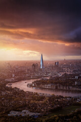 A cloudy winter sunset with sun and rain clouds behind the skyline of London, England, with golden and red colours