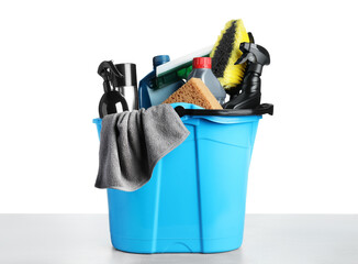 Wall Mural - Bucket with many different car wash products on grey table against white background