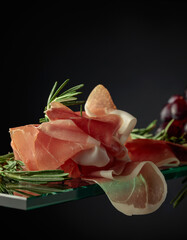 Wall Mural - Prosciutto with rosemary and grapes.