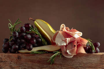 Wall Mural - Prosciutto with rosemary, pear, and grapes.