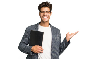young teacher caucasian man holding a book isolated showing a copy space on a palm and holding anoth