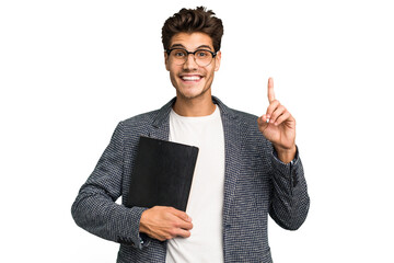 Young teacher caucasian man holding a book isolated showing number one with finger.