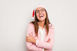 © Asier - Business caucasian woman wearing a christmas hat isolated on white background laughing and having fun.