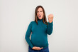 © Asier - Pregnant caucasian woman isolated on white background showing fist to camera, aggressive facial expression.