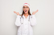 © Asier - Young caucasian doctor woman wearing a santa hat isolated on white background
