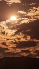 Wall Mural - Timelapse of dramatic sunset with orange sky in a sunny day.