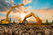 Crawler Excavators are digging the soil in the construction site on the sunset sky backgrounds,With bucket lift up