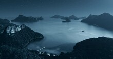 Night Island Closeup. Aerial Blue Moon Light Sky Background. Beautiful Tropical Rocky Mountain Above Ocean Water. Midnight Starry Seascape Drone View. Travel Concept. Exotic Hawaii Vacation Tourism.