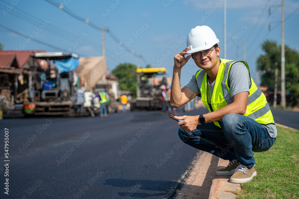 Paving Insection Work Asian young civil engineer wear safety uniform under inspection and ...