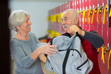 senior couple in fitness club locker room