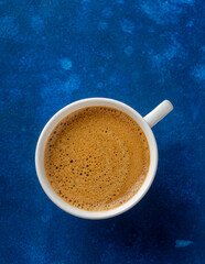 Cup of fresh espresso with delicious crema, top view