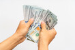 © Iana Alter - Man holding new dollar bills again white background. American cash, money in hand