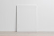 Art canvas mockup on the floor leaning against the white wall
