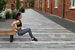 Sporty woman doing triceps dip exercise on the bench outdoor