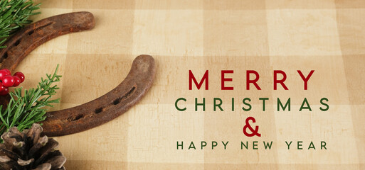 Sticker - Western industry Merry Christmas greeting with old horseshoe on tan plaid background for holiday.