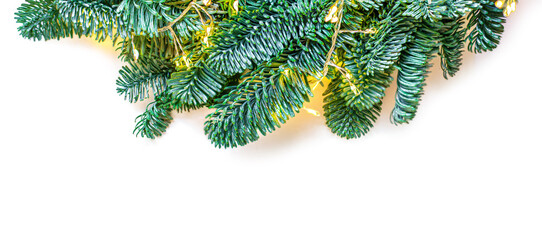 Wall Mural - christmas tree border isolated on white background. fir tree branches with sparkling golden lights g