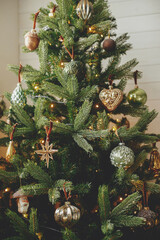 stylish christmas tree with vintage baubles and golden lights. modern decorated christmas tree with 