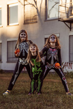 Children Celebrating A Halloween Costume Party In The Back Garden