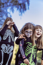 Children Celebrating A Halloween Costume Party In The Back Garden
