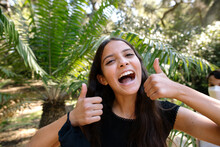 Teen Girl Smiling Big Gives Two Thumbs Up