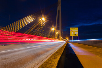 Traffic motion lights on a bridge during night