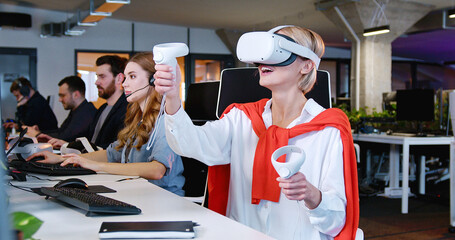 Wall Mural - Caucasian woman in VR glasses moving joysticks in air. Female in headset having virtual reality experience. Moving hands in air. Futuristic. Augmented. Gaming of future.