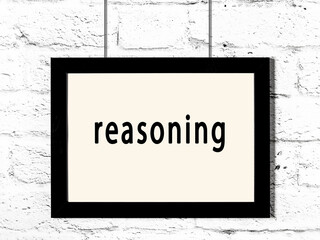 Wall Mural - Black frame hanging on white brick wall with inscription reasoning