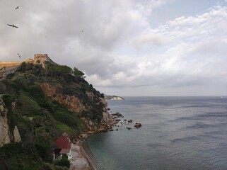 Wall Mural - Beautiful coastal scenery with a castle on the top of a hill