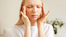 Stressed Unhealthy Woman Feeling Tired Have Terrible Strong Headache Pain. Female Suffering From Migraine Massaging Temples.	