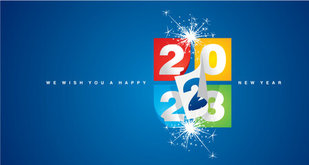 Canvas Print - Happy New Year 2023 greeting card design template on blue background. New Year 2023 start concept. Colorful calendar pages with 2023 turn in the wind and the new year begins