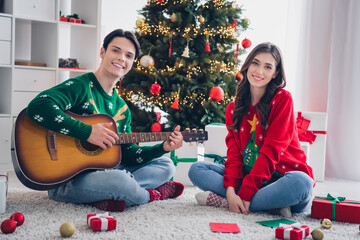 Sticker - Full size photo of two peaceful people sit carpet floor play acoustic guitar spend magic time indoors