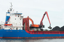 Cargo Ship On Embarkation Of Coal In The Port